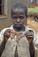 Ugandan boy proudly poses with colorful moth