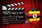 Ugandan cinematography, film industry, cinema in Uganda. Clapperboard with and film reels on the red fabric, 3D rendering