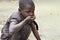 Ugandan girl drinks unclean drinking water