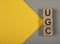 UGC user generated content on dices on yellow and gray banner background with copy space for text