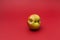 Ugly apple with flaws on a red background. Selective focus, copy space. Concept - Food waste reduction. Using in cooking imperfect