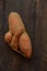 Ugly food. Deformed organic carrot on wooden background. Misshapen produce, food waste problem concept. Minimal style. Flat lay.