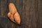 Ugly food. Deformed organic carrot on wooden background. Misshapen produce, food waste problem concept. Minimal style. Flat lay.