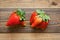 Ugly fruit. Misshapen produce concept. Organic deformed strawberries on wood background