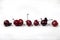 Ugly funny cherries and sweet cherries on a white background. Healthy food concept