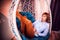 Ugly girl in a white shirt and red jeans on a white wicker hanging chair