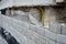 Ugly holding a road notch of a bridge forecourt tunnel. retaining wall with concrete grouting is covered with fake, optically pret
