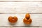 Ugly kiwi fruits on a white wooden background. Fruit or food waste concept. Top view, close-up