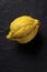 Ugly lemon on a dark background. Closeup. Copy space