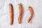 Ugly misshapen carrots on craft paper background. Concept of zero waste production. Top view. Copy space. Non gmo vegetables