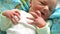 Ugly newborn baby with tiny hand in focus. shaking hands