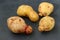 Ugly organic abnormal vegetables - potatoes on dark background, Concept organic vegetables, horizontal