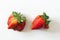Ugly organic home grown strawberries on white wood background. Strange funny imperfect fruits and vegetables, misshapen produce, f