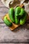 Ugly organic twisted cucumbers on wooden table. Copy space