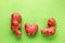 Ugly potato on a green plaster background. Vegetable or food waste concept. Top view, close-up