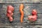 Ugly potato and twisted carrot on an old weathered wooden background. Vegetables or food waste concept. Top view, close-up
