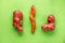 Ugly potatoes and carrots on a green background. Vegetable or food waste concept. Top view, close-up