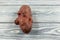 Ugly potatoes on a light wooden background. Horizontal orientation