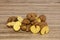 Ugly potatoes on a wooden background. Horizontal orientation