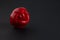 Ugly red bell pepper on dark background with copy space. Concept - reduction of food organic waste. Deformed, crooked vegetables