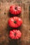 Ugly tomatoes on wooden background. Concept of zero waste production. Top view. Copy space. Non gmo vegetables