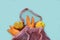 Ugly vegetables and fruits in a string bag: potatoes, carrots and an apple. Mesh shopping bag Eco bag. The concept of ecology, not