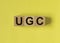 UGS or User-generated content acronym for social media on yellow