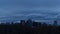 UHD 4k Time Lapse movie of moving white clouds and blue sky over downtown city of Portland Oregon from dusk into blue hour