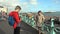 UK, Brighton. Young couple taking photo on the coast. Happy lovers, woman and man traveling on vacation on ocean. Girl