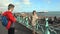 UK, Brighton. Young students taking photo on the coast. Happy lovers, woman and man traveling on vacation on ocean. Girl