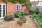 UK garden in autumn with gravel, patio and French doors