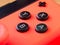 UK, March 2020: Close up of red neon joy con controller Nintendo Switch