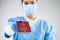 UK NHS doctor holding red global immunity passport