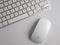 UK, October 2019: Apple mac mouse and wireless keyboard on white background