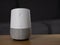 UK, October 2019: Google Home smart speaker on wooden table in lounge
