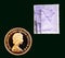 UK purple stamp with portrait of Elizabeth II and 1980 Australian Gold sovereign on black background