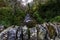 UK river in autumn fall with top of dry stone wall of bridge in foreground