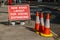 A UK road sign with orange traffic cones telling users that the layout has changed to allow for social distancing during Covid 19