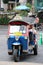 Uk Tuk is a three-wheeled motorized vehicle used as a taxi with passengers on the road at Ploenchit Road.