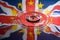 UK Union Jack and the stars of the European Union reflected in a water splash with a single drop of water falling