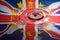 UK Union Jack and the stars of the European Union reflected in a water splash with a single drop of water about to land