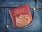 UK United Kingdom passport in pocket jeans. Travel, tourism, emigration and passport control concept