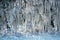 UK weather with icicles formed from splashed road water