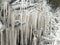 UK weather with icicles formed from splashed road water