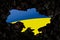 Ukraine against the background of burnt coals. The colors of the Ukrainian flag are blue and yellow on a dark back