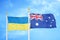 Ukraine and Australia two flags on flagpoles and blue sky