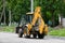 Ukraine, Chernihiv May 29, 2021: road repairs in the historic city center. A yellow tractor is driving on the road