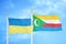 Ukraine and Comoros two flags on flagpoles and blue sky