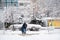 Ukraine Dnipro 26.12.2021 City in winter with cars in the snow and people trying to get to the robot in the morning after snowfall