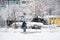 Ukraine Dnipro 26.12.2021 City in winter with cars in the snow and people trying to get to the robot in the morning after snowfall